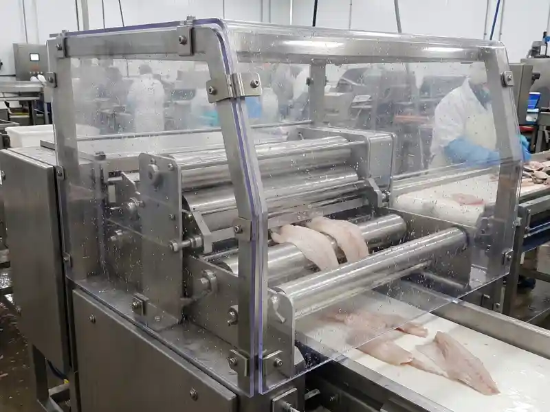 A machine guard made of polycarbonate used in seafood processing machinery.