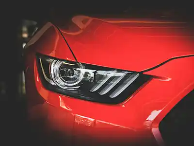 Polycarbonate is a common material used for automotive headlight lenses.